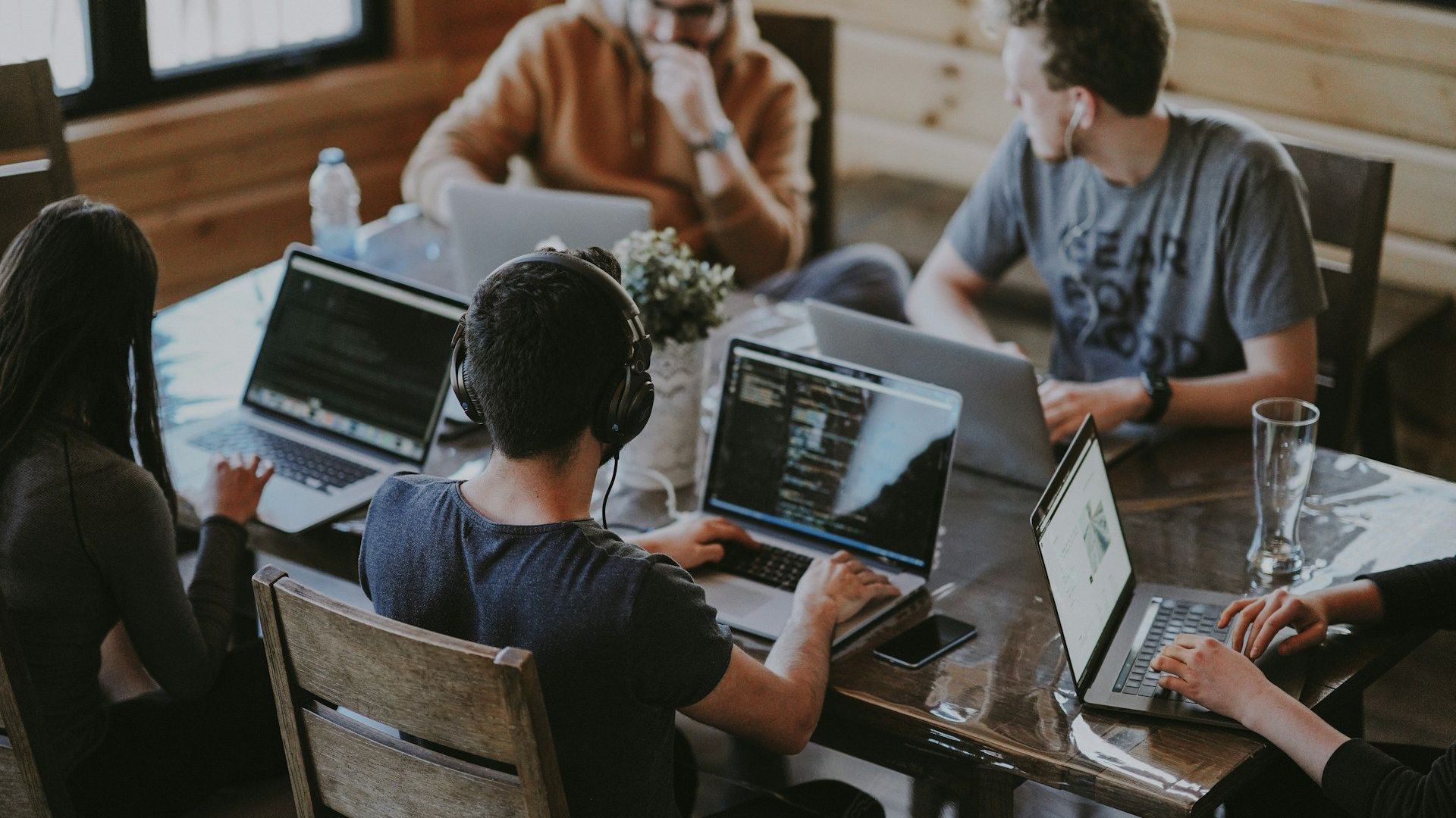 A collaborative team discussion around a laptop